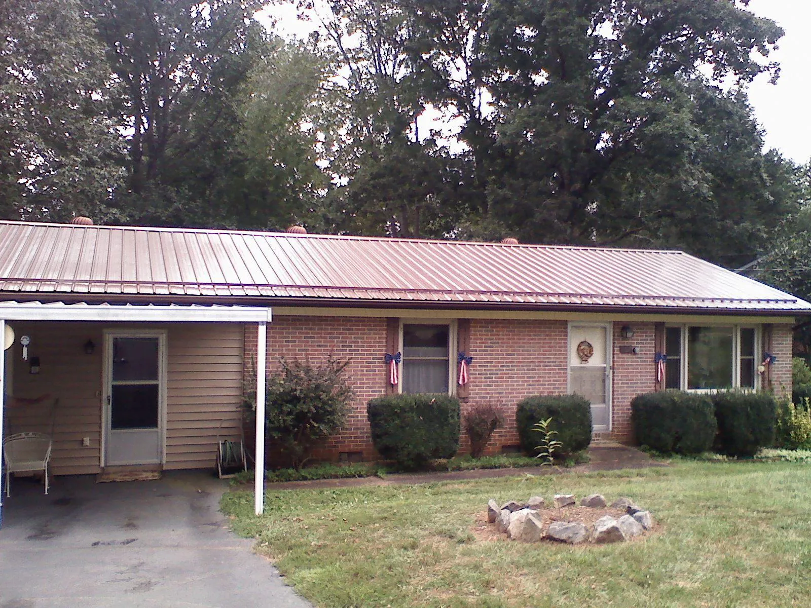 Bronze metal roof and carport on a brick ranch home — Roof Repair work by our crew in Benton City