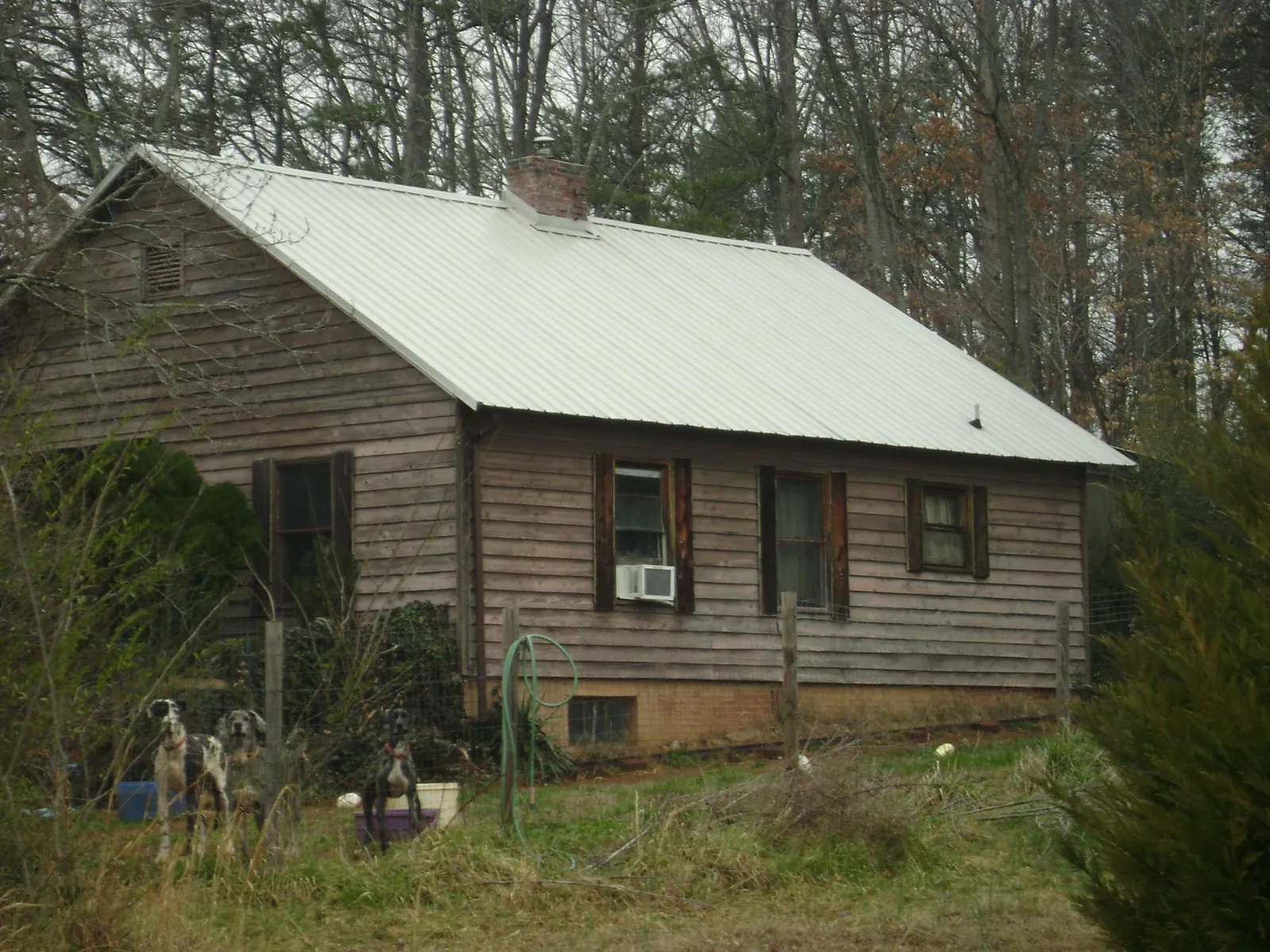 White metal roof on an old wood sided farmhouse, from a Metal Roof Installation job in Benton City